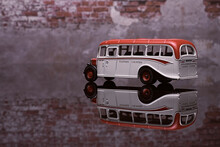 Side View Of Old Bus With Brick Wall Background