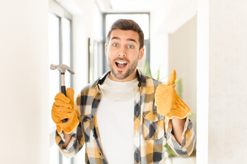 handyman feeling proud, carefree, confident and happy, smiling positively with thumbs up