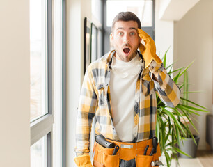 handyman looking surprised, open-mouthed, shocked, realizing a new thought, idea or concept