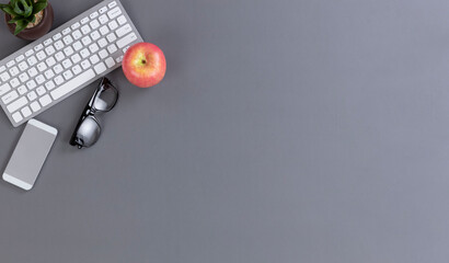 Back to school or work concept with apple and wireless technology on desk