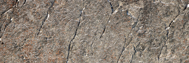 Wall Mural - Rock texture. Snow and cracks on the surface of the cliff. Natural stone background.