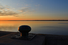 Sunset On St Lawrence River, Mooring Bollard In Foreground