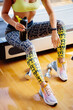 © shevtsovy - Torso of slim attractive female with protein shake in sportswear. unrecognizable fit woman relax and drinks protein diet shake in gym. Copy space for text.