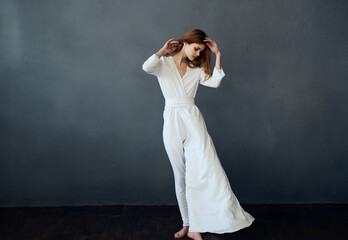 Woman in white dress attractive glamor performance gray background