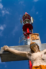 Transmission tower and crucified Jesus Christ in Szekszard