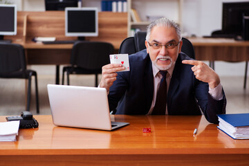 Sticker - Old male employee playing cards at workplace