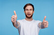 © SHOTPRIME STUDIO - Cheerful man in white t-shirt tattoo on his arms cropped view fashion