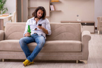 Poster - Young man drinking alcohol at home