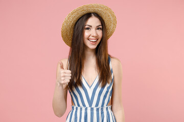 young excited positive cheerful caucasian woman in summer clothes striped dress straw hat show thumb