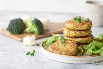 veggie burgers with quinoa, broccoli, cauliflower served with salad. plant based food. space for text