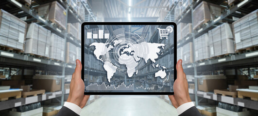 Poster - Hands with digital tablet on the background of a warehouse. Online trade and logistics concept