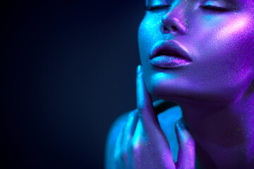 Glowing skin with sequins. Fashion model woman in colorful bright sparkles and neon lights posing in studio, portrait of beautiful sexy girl, trendy make-up. Art design make up. Glitter Vivid makeup.