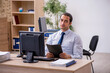 © Elnur - Young male employee sitting in the office