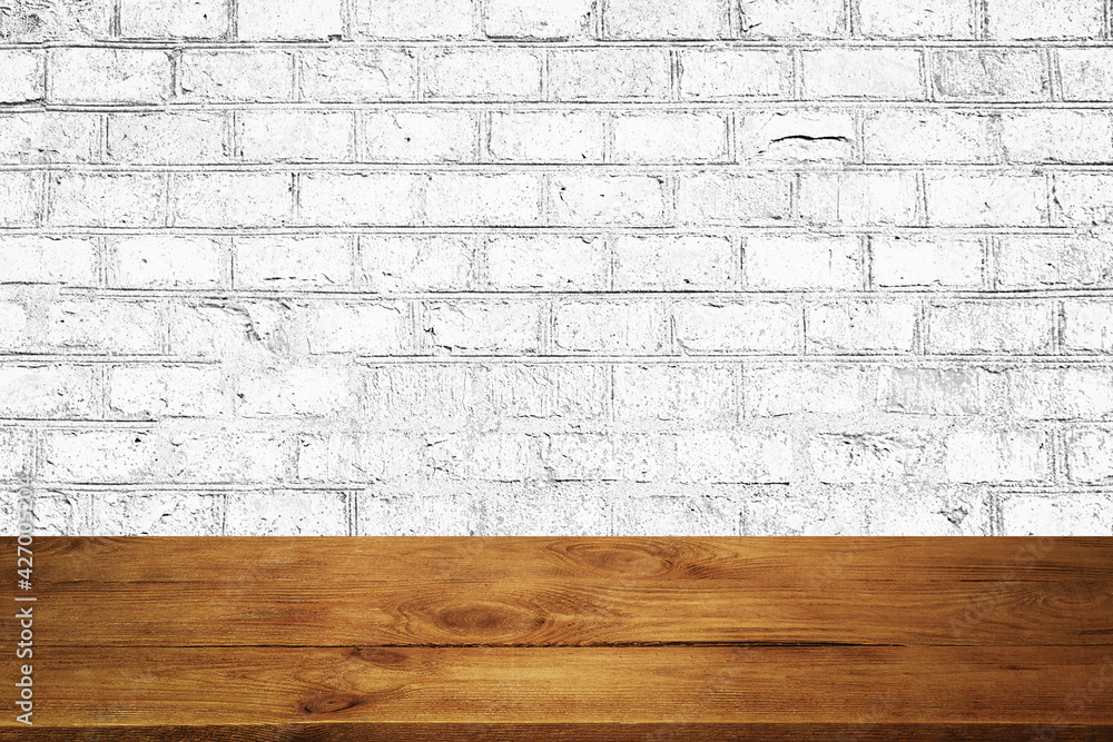 The background is blank wooden boards and a textured brick wall with lighting and vignetting. - obrazy, fototapety, plakaty 