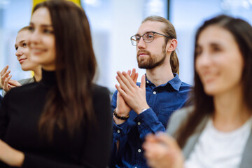 Group of people take notes,  listening to a lecturer or speaker at a conference. Business group meeting seminar training concept. Planning, analysis, collaborate work in teamwork.