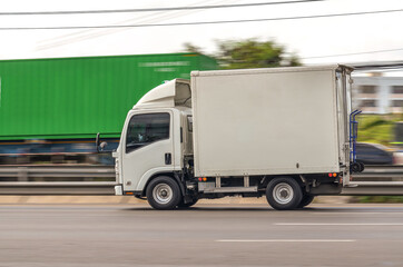 Small white truck for logistics running on the road, Motion image, Logistics service concept