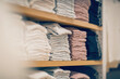 Stacks of clothes. Shopping in store. Clothing on the shelves in shop for sale.