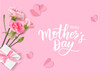 Happy Mothers day. Calligraphic greeting text. Holiday design template with realistic pink carnation flowers, gift box and paper hearts on pink background. Vector stock illustration.