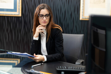 Secretary at work in her office with a desktop pc