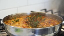 Pan Of Rich Sauce Cooking And Bubbling In Pan