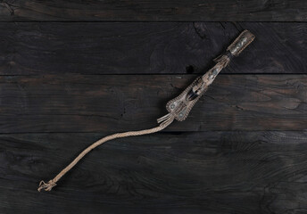 Sticker - ancient whip isolated on wooden background