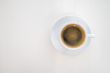 Fototapeta Mapy - Top view of white cup of hot black coffee (Americano) with plate on white desk with copy space.