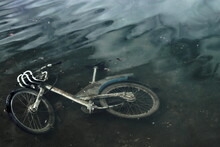 Dirty Abandoned Bike Lying Under The Water.