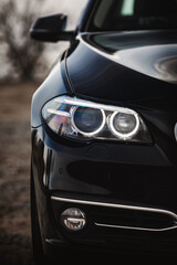 Wall Mural - Modern car headlights close up. Prestigious auto wallpaper.