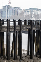 Wall Mural - River Thames low tide. London in rain. Empty streets of London during national lockdown UK, 2021