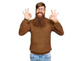 Canvas Print - Young irish redhead man wearing casual clothes and glasses relaxed and smiling with eyes closed doing meditation gesture with fingers. yoga concept.