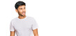 © Krakenimages.com - Young handsome man wearing casual white tshirt looking away to side with smile on face, natural expression. laughing confident.