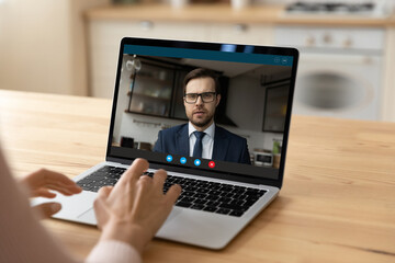 Wall Mural - confident young businessman in glasses on pc screen consult support female client by video call. mil