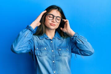 Canvas Print - Young caucasian woman wearing casual clothes and glasses with hand on head, headache because stress. suffering migraine.