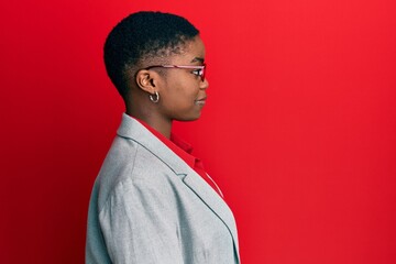 Sticker - Young african american woman wearing business jacket and glasses looking to side, relax profile pose with natural face with confident smile.