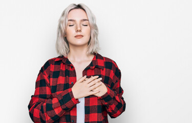 Poster - Young blonde girl wearing casual clothes smiling with hands on chest with closed eyes and grateful gesture on face. health concept.