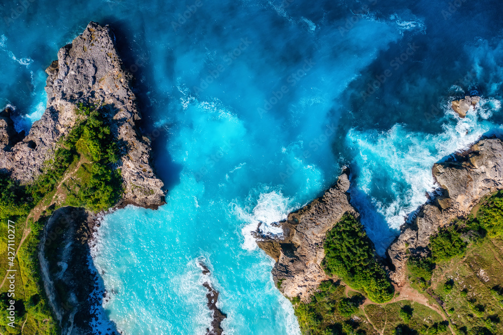 Waves and rocks as a background from top view. Blue water background from top view. Summer seascape from air. Bali island, Indonesia. - obrazy, fototapety, plakaty 