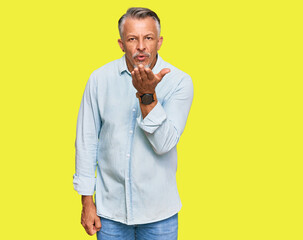 Poster - Middle age grey-haired man wearing casual clothes looking at the camera blowing a kiss with hand on air being lovely and sexy. love expression.