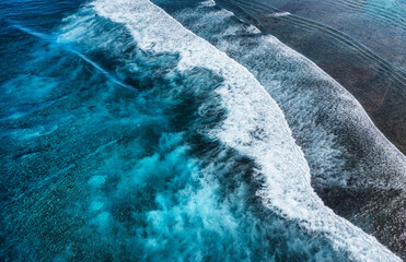Wall Mural - coast with high waves as a background from top view. blue water background from top view. summer sea