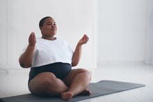 Beautiful Plus Size Woman Doing Yoga Exercise At Home