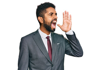 Wall Mural - Young african american man wearing business clothes shouting and screaming loud to side with hand on mouth. communication concept.