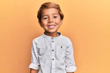 adorable latin kid wearing casual clothes with a happy and cool smile on face. lucky person.