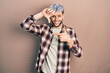 Young hispanic man with modern dyed hair wearing casual shirt smiling making frame with hands and fingers with happy face. creativity and photography concept.