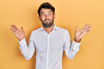 Poster - Handsome man with beard wearing casual white t shirt clueless and confused with open arms, no idea and doubtful face.