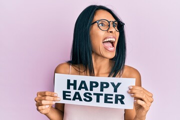 young african american woman holding happy easter message paper angry and mad screaming frustrated a