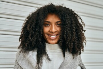 Poster - Young african american woman smiling happy standing at the city.