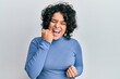 © Krakenimages.com - Young hispanic woman with curly hair wearing casual clothes celebrating surprised and amazed for success with arms raised and eyes closed