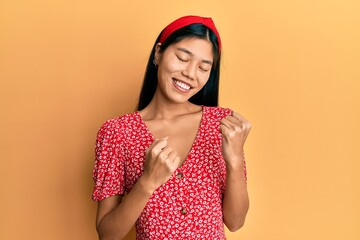 Sticker - Young chinese woman wearing casual clothes celebrating surprised and amazed for success with arms raised and eyes closed