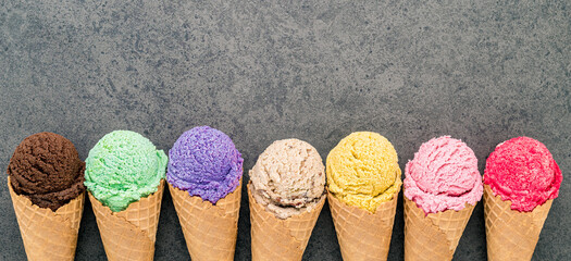 Fototapete - Flat lay various of ice cream cones set up on dark stone background  . Summer and Sweet menu concept.
