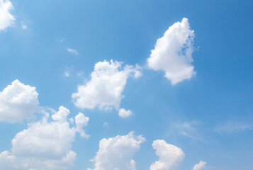 Wall Mural - Abstract white fluffy clouds and  Blue sky in sunny day background.Natural Celestial World  concept with blue sky and clouds  Use as background.