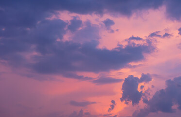 Wall Mural - Beautiful sky painted by the sun leaving bright golden shades.Dense clouds in twilight sky in winter evening.Image of cloud sky on evening time.Evening sky scene with golden light from the setting sun